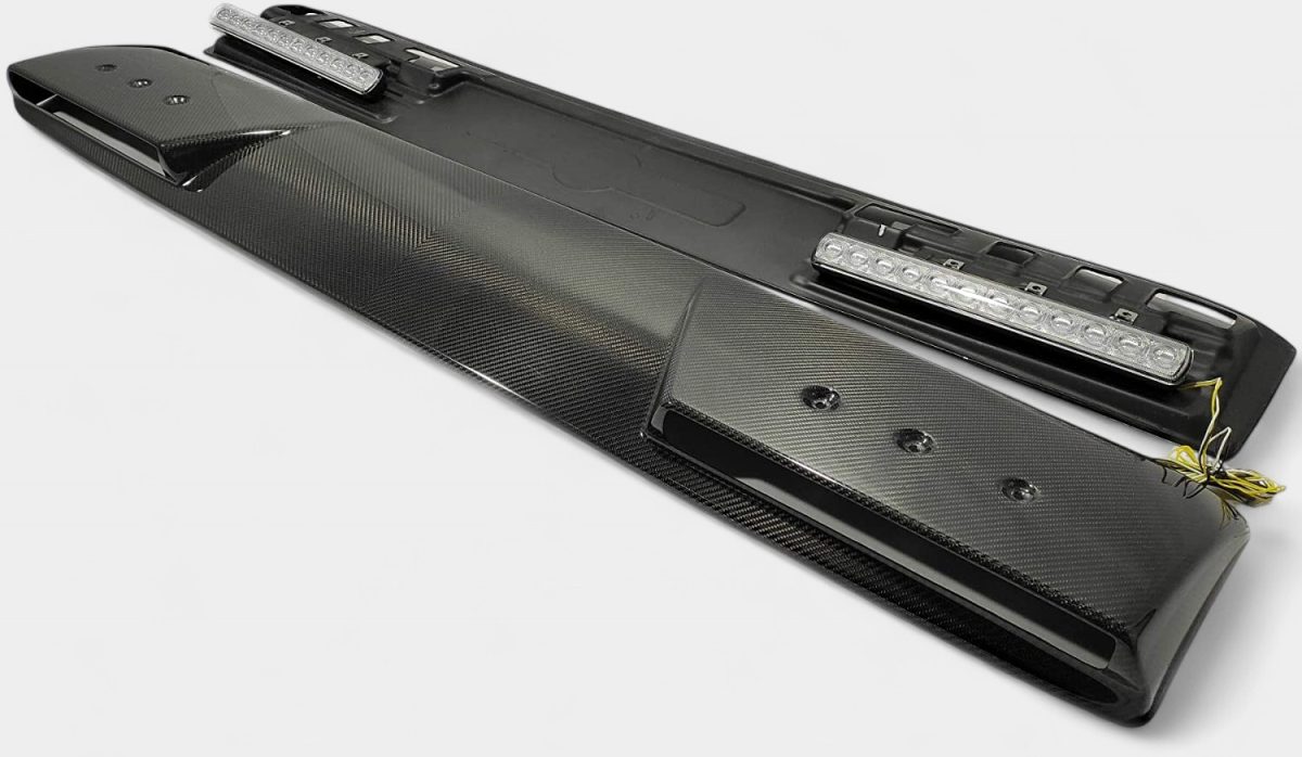 Wide perspective showing full gloss carbon fiber front roof spoiler with pre-mounted LED light modules
