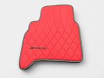 Direct shot displaying passenger side red quilted leather floor mat with dark contrast piping