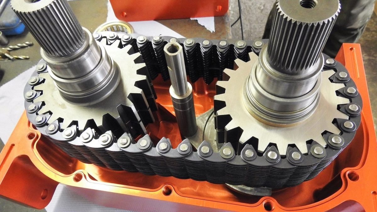 Internal view of Tibus transfer case showing chain-driven gears and reinforced shafts.