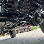 Close-up view of the drive shaft and differential for the original middle axle of a Mercedes-Benz G-Class W463 6×6, showing suspension components and undercarriage details.