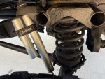 Dual Bilstein shock absorbers mounted next to heavy-duty coil spring on W463 6×6 suspension.