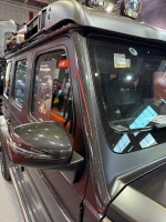 Close-up view of precision carbon fiber trim edge fitting against G-Wagon upper windshield frame