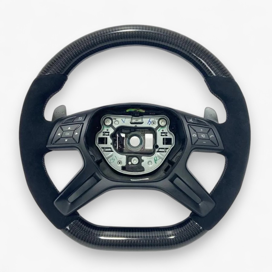 Carbon Fiber & Alcantara Steering Wheel for Mercedes-Benz G-Class W463 GL X166 ML W166 Flat-bottom carbon steering wheel with Alcantara grips and matte black center for Mercedes GL X166 / ML W166.