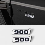 Close-up view showing white 900 metallic plate mounted below BITURBO text on black vehicle