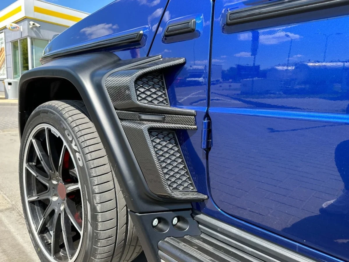 Straight-on perspective showing dark composite air vent trim attached to widebody fender