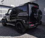 Rear angle view of black vehicle displaying G800 style rear bumper, spare tire cover, and roof spoiler