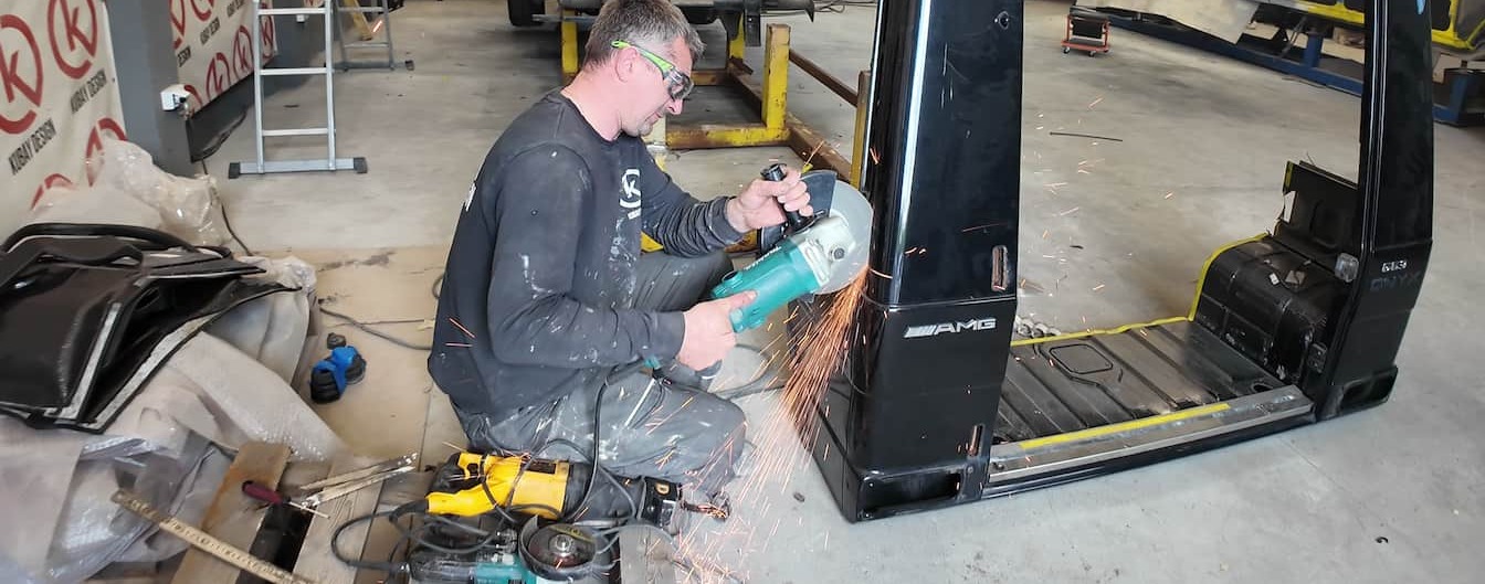Cutting the ONYX Body Panels for 6×6 Conversion Kubay Design technician cutting an ONYX Mercedes G-Class body panel during 6x6 conversion