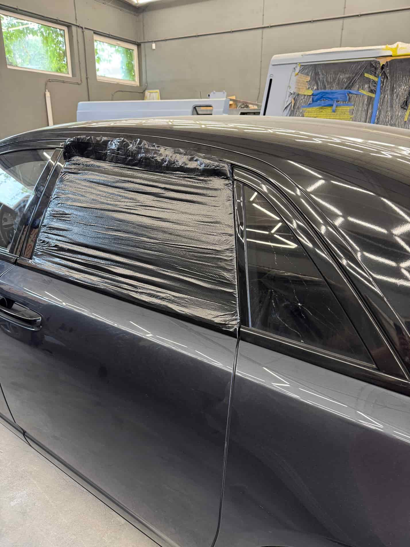 Broken rear window and molding damage on Rolls-Royce Ghost before repair